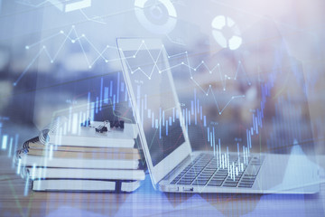 Forex Chart hologram on table with computer background. Multi exposure. Concept of financial markets.
