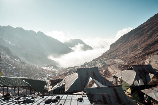 Cityscape Ariel View of Changu lake surrounded by mountains. Dramatic clouds over roof tops of Sikimise, Nepalis, Lepchas, Tibetan Buddhist huts. Tsomgo Lake, Gangtok, Sikkim, December 26, 2018: