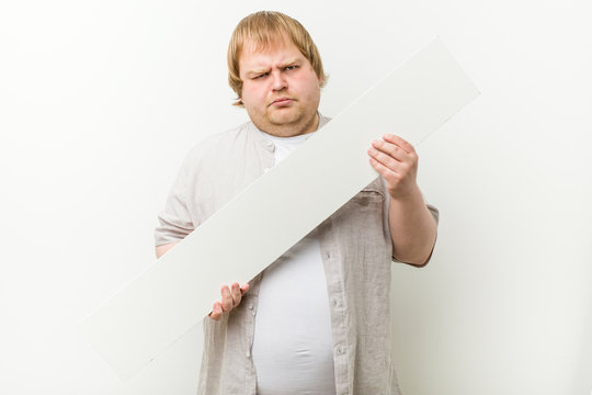 Caucasian crazy blond fat man with a placard