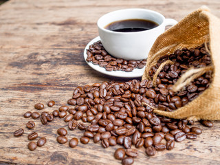 Coffee beans are spilling from the bag, ready to give freshness and alongside the businessman