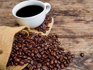 Coffee beans are spilling from the bag, ready to give freshness and alongside the businessman