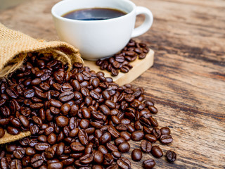 Coffee beans are spilling from the bag, ready to give freshness and alongside the businessman