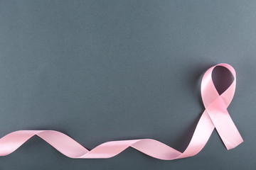 The pink colored ribbon - international symbol of breast cancer awareness and moral support for...
