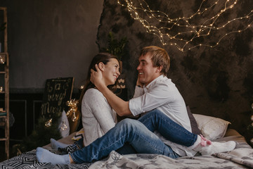 Naklejka premium Romantic couple in love feeling happiness about their romance spending christmas eve together- Image