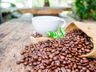 Coffee beans are spilling from the bag, ready to give freshness and alongside the businessman