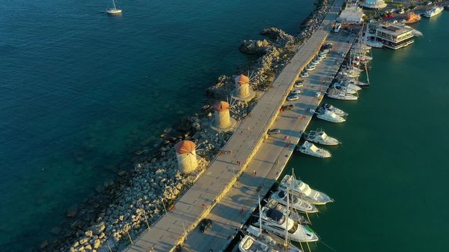 famous mills of the port of Mandraki in beautiful setting sun, Rhodes Greece, drone view