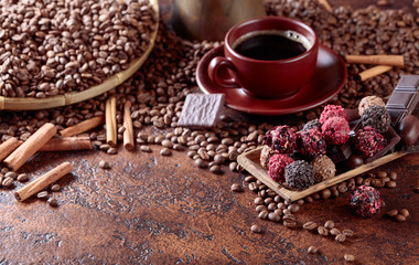 Various chocolates  and cup of black coffee.