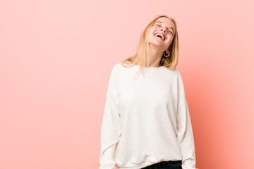 Obraz premium Young blonde teenager woman relaxed and happy laughing, neck stretched showing teeth.
