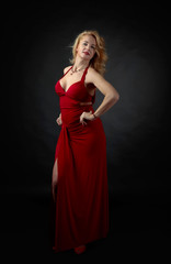 Fototapeta premium Attractive middle age woman in red evening dress.
