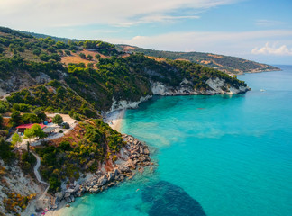 Drone aerial view of a stony beach. Panorama with nice sand, lagoon and clear blue water. Famous tourist destination in South Europe.