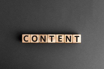 Content - word from wooden blocks with letters, content concept, random letters around, white ...