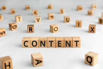 Content - word from wooden blocks with letters, content concept, random letters around, white ...