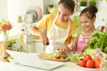 Portrait of cute brother and sister cooking