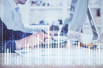 Forex graph with businessman working on computer in office on background. Concept of hardworking. Closeup. Multi exposure.
