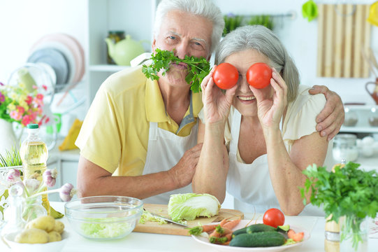 Portrait of a senior couple cooking together at kitchen