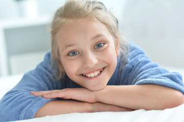 Portrait of little girl posing at home on bed
