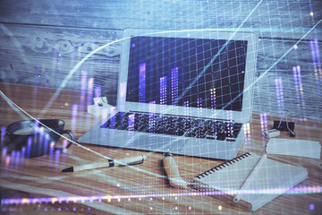 Financial graph colorful drawing and table with computer on background. Double exposure. Concept of international markets.