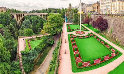 Panoramic city view of Luxembourg city with the famous Adolphe bridge and Constitution square and Park © EdNurg
