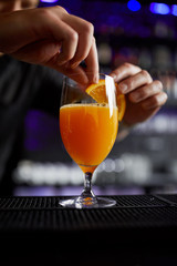 man holding a glass of orange juice