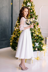 Fototapeta premium The bride holds in her hands a beautiful winter wedding bouquet. The bride in a beautiful wedding dress. Winter wedding