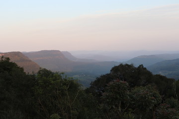 An indescribable landscape of the Belvedere Lookout of the Vale do Quilombo (Quilombo Valley) on a late afternoon with fog that makes the clouds cover the entire valley.