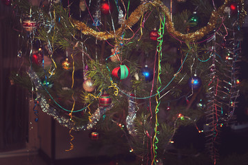 winter holidays and interior concept - close up of decorated christmas tree