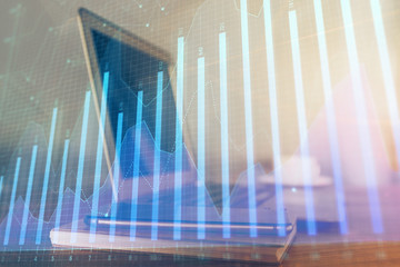Stock market chart hologram drawn on personal computer background. Multi exposure. Concept of...
