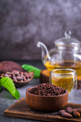 Hot Cacao Tea. Fresh hot chocolate herbal tea made of cacao bean flakes, which is rich in flavonoids and antioxidants, served in glasses, Selective Focus