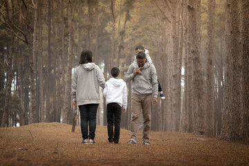 Fototapeta premium Young family with children having fun in nature