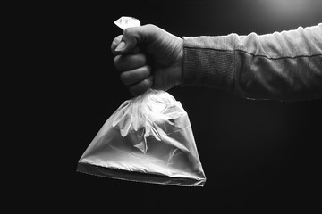 Female hand is holding a empty plastic bag filled with clean air. Environment and ecology concept.