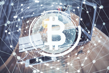 Double exposure of blockchain and crypto economy theme hologram and table with computer background. Concept of bitcoin cryptocurrency.