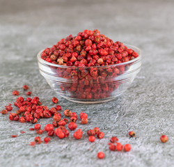 Pink pepper in a glass bowl.