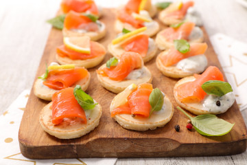 festive canape, toast with salmon, cream and basil