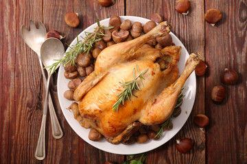 baked chicken with chestnut on wood background