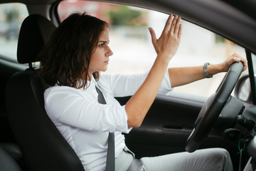 Fototapeta na wymiar Angry young woman in car