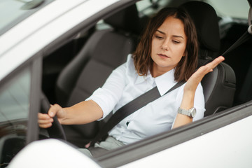 Angry young woman in car