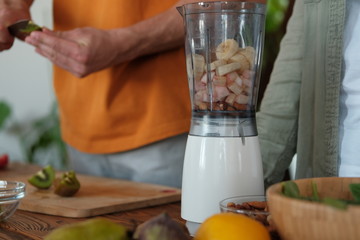 Young married couple is preparing a smoothie