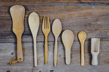 wooden surface and a wooden spoon and fork on wood table.