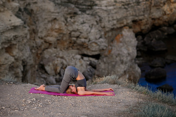 Sporty girl practicing yoga outdoor. Healthy lifestyle concept.