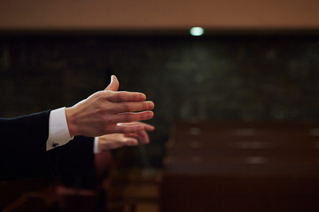 Orchestra conductor's hand background on stage 