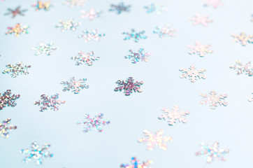 Many shimmering snowflakes on a blue background.