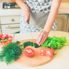 Making healthy vegetable salad in the kitchen.