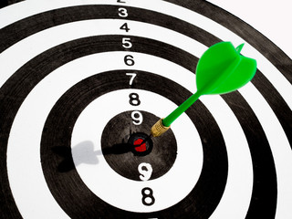 Target with green dart focus on bull's eye, Setting challenging business goals And ready to achieve the goal concept