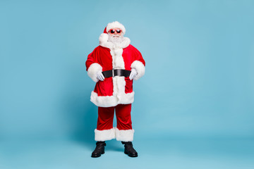 Full length body size view of his he nice confident cheerful cheery fat bearded Santa wearing warm winter coat look outfit clothing ho-ho-ho isolated over blue turquoise pastel color background