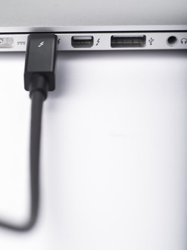 LONDON-JAN.01: photo studio of a thunderbolt cable linked to a laptop on 18th january, 2013 in London,UK. Intel thunderbolt is a new connectivity solution that offer a speed of transfer faster 10 time