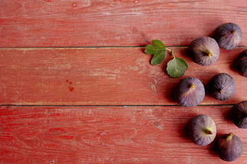 fresh figs in a red old wooden background.
