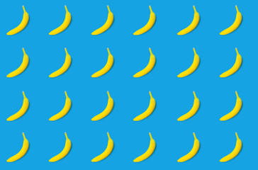Pattern.Yellow bananas on a blue background..Holiday concept