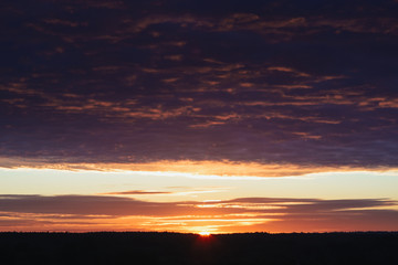 Dawn, field, colorful clouds, rising sun