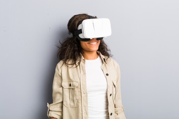 Young african american woman using a virtual reality glasses