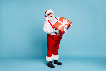 Full length photo of funny funky fat santa claus with big belly abdomen hold gift box for christmas...